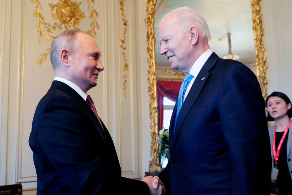 US president Joe Biden, right, and Russian president Vladimir Putin, shake hands during their meeting in Switzerland