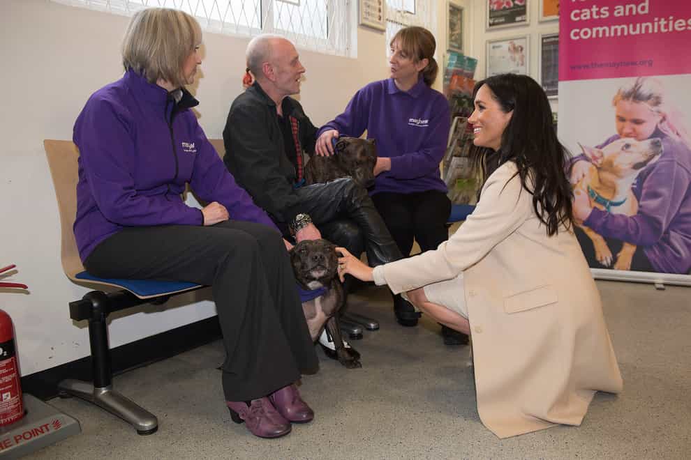 The Duchess of Sussex meets Wully Struthers and his staffies Azzy and Gallis during a visit to animal welfare charity Mayhew