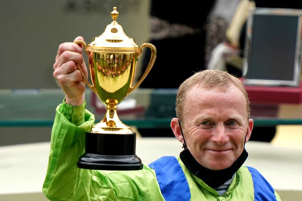 Joe Fanning celebrates with the trophy after winning the Gold Cup on Subjectivist