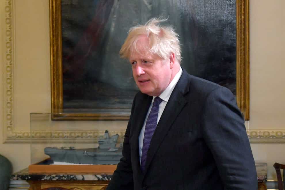 Prime Minister Boris Johnson walking through a room at No 10