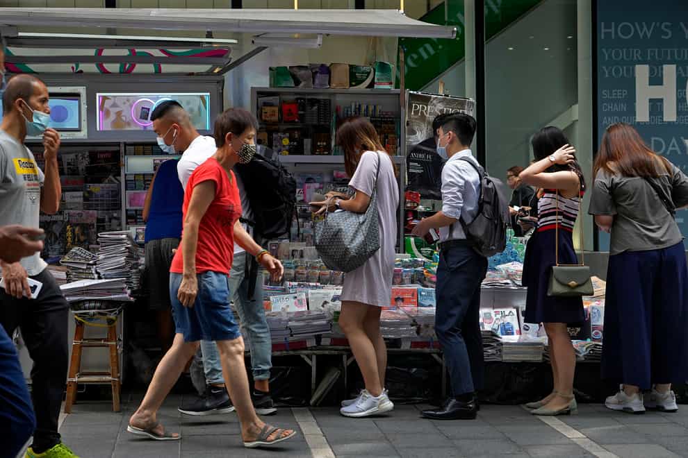 People queue up to buy Apple Daily at a downtown street in Hong Kong on Friday