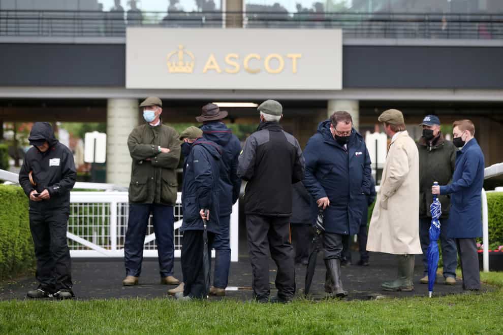 <p>Ground staff gather to conduct a course inspection during day four of Royal Ascot</p>