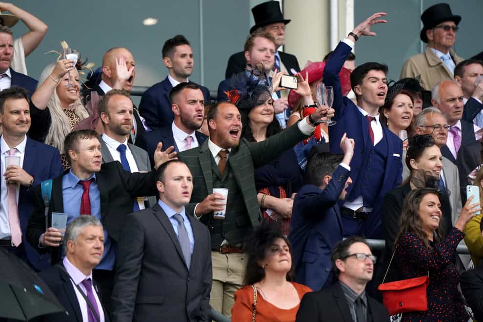Racegoers cheer during the Coronation Stakes
