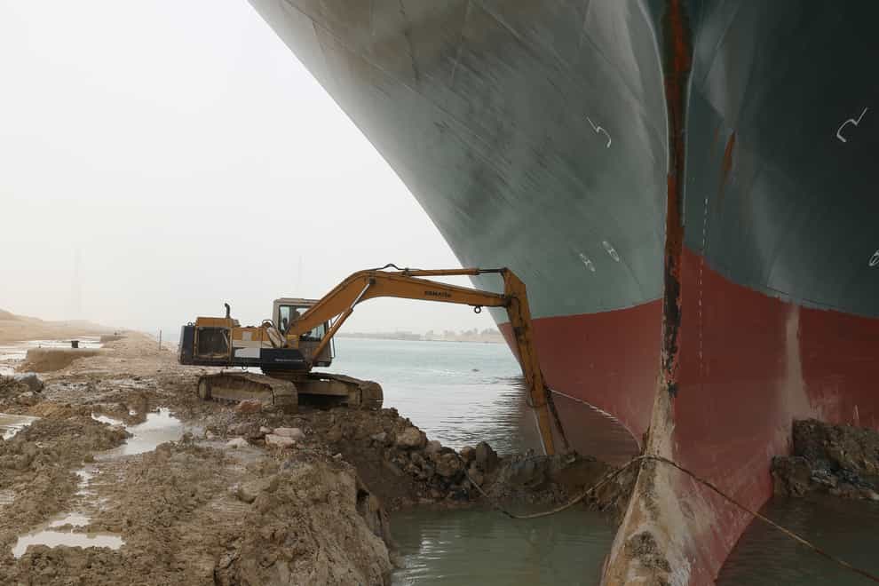 A digger being used to free the Ever Given (Suez Canal Authority/PA)