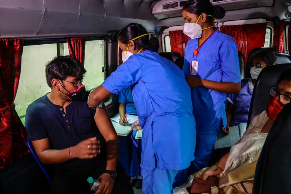 A health worker administers a Covid-19 vaccine in Kolkata, India
