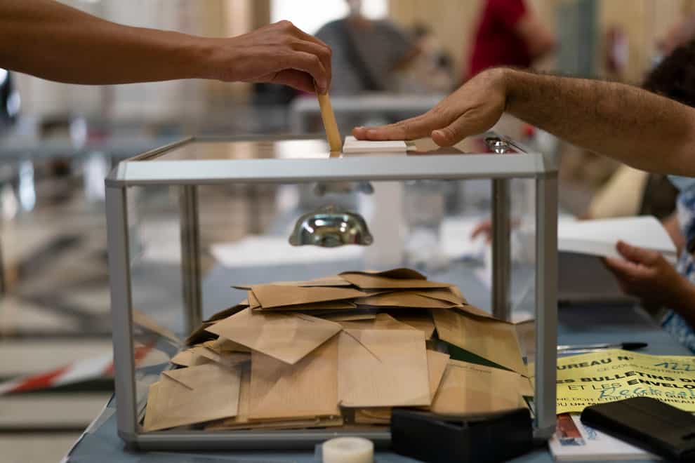 A woman casts her vote during regional elections in Marseille