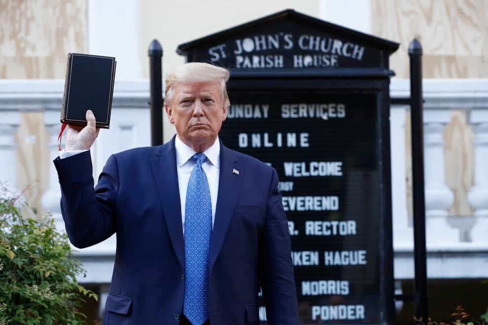 Donald Trump holds a Bible outside St John’s Church