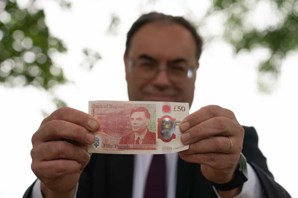 <p>Andrew Bailey holds a new £50 note</p>