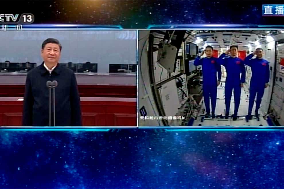 Composite pic showing Chinese astronauts saluting as they talk with Chinese President Xi Jinping
