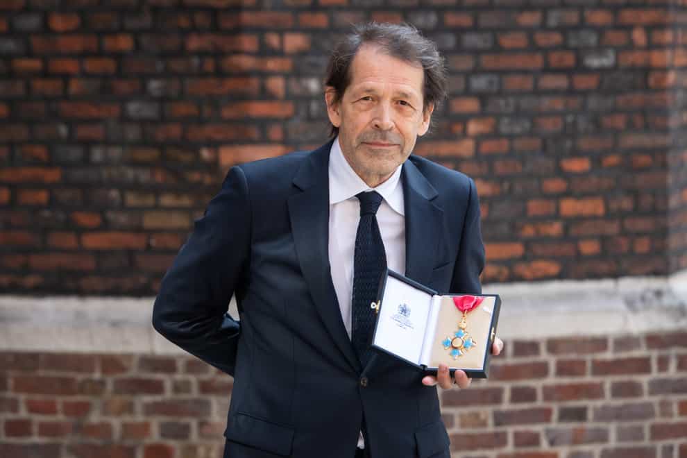 Peter Saville with his CBE medal, after an investiture ceremony at St James’s Palace