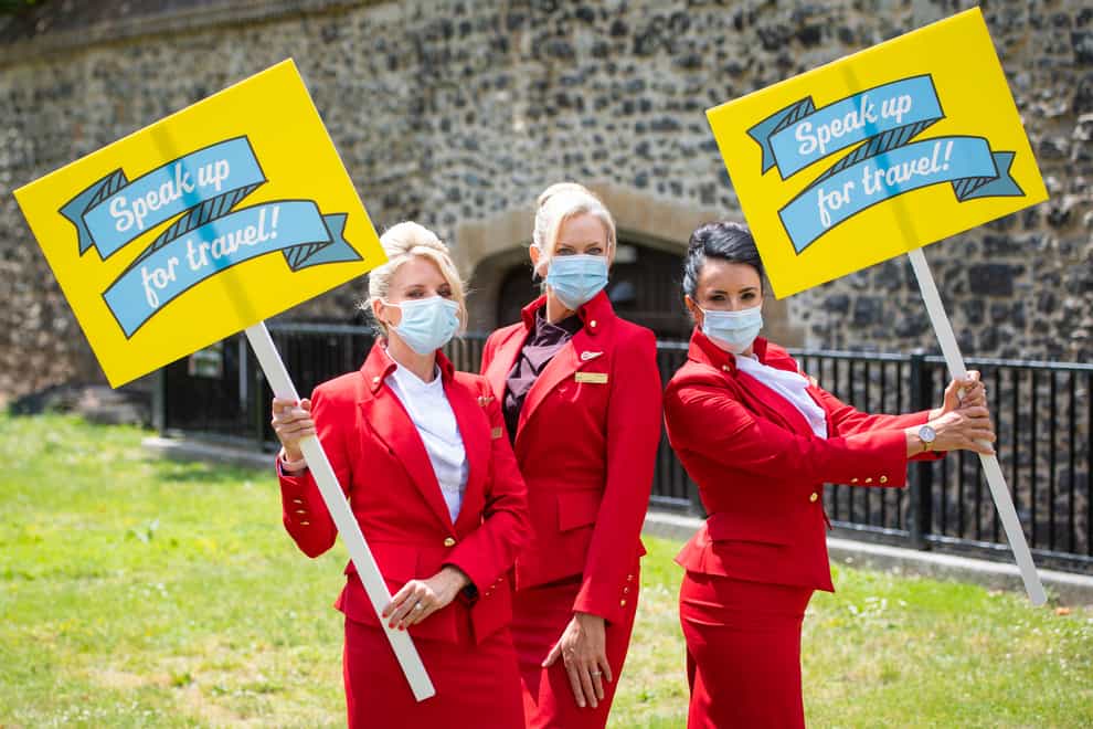 Virgin cabin crew join a protest by members of the travel industry on College Green, Westminster, central London, during a Travel Day of Action (Dominic Lipinski/PA)