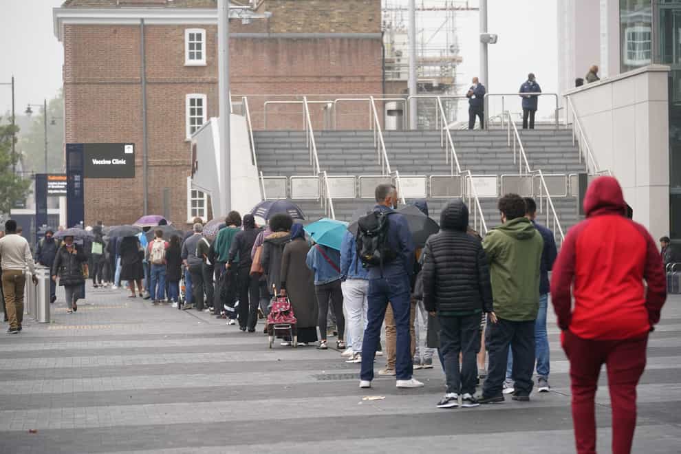 People queue at an NHS vaccination clinic