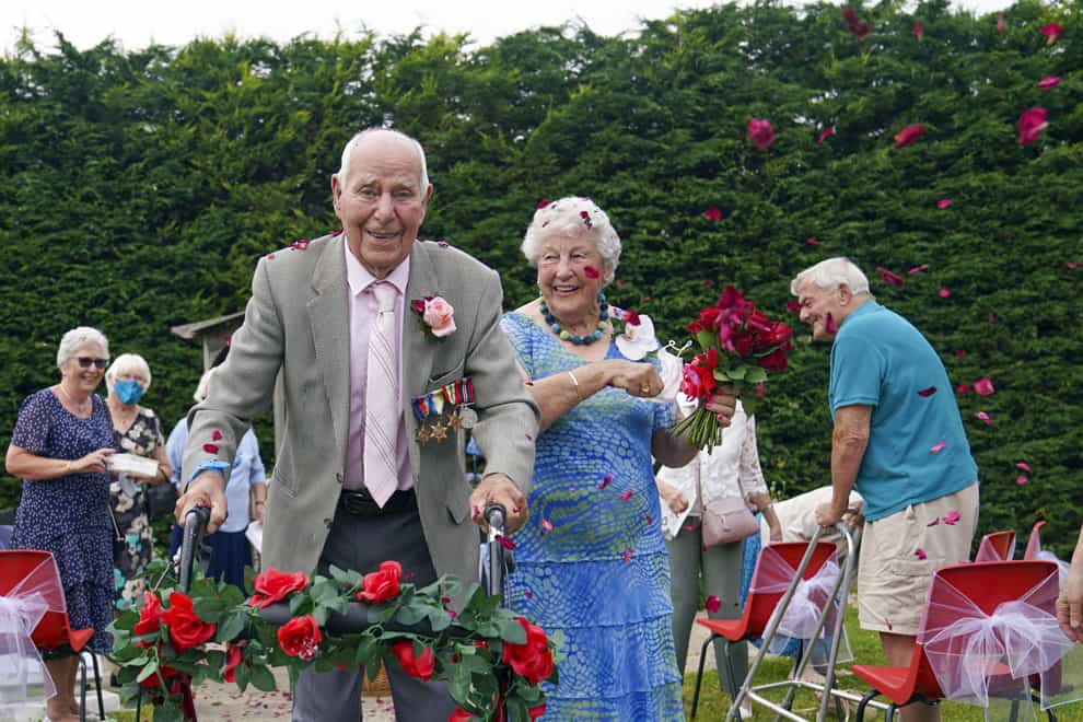 Couple in their 90s walk down the aisle after renewing their wedding blessings.