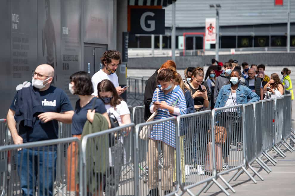 People queue for a mass coronavirus vaccination centre at Arsenal’s Emirates Stadium