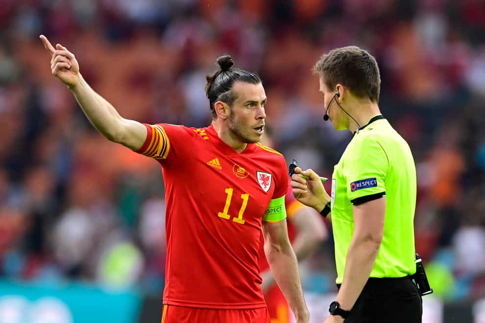 Wales’ Gareth Bale (left) argues with referee Daniel Siebert