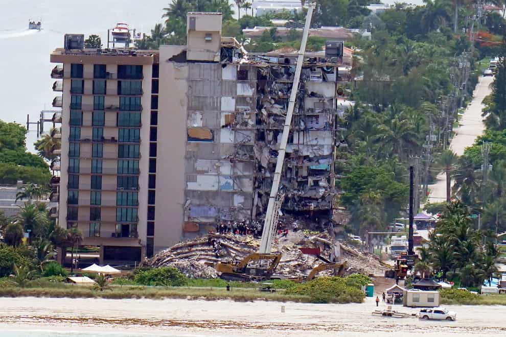Workers search in the rubble at the Champlain Towers South Condo