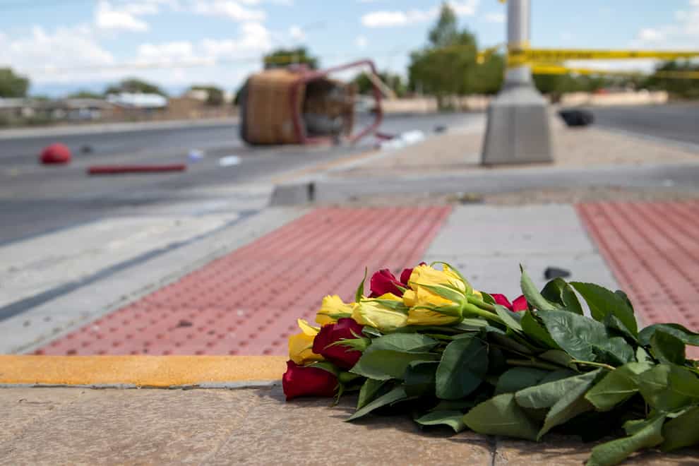 A bouquet of flowers placed near the basket of a hot air balloon which crashed in Albuquerque on Saturday