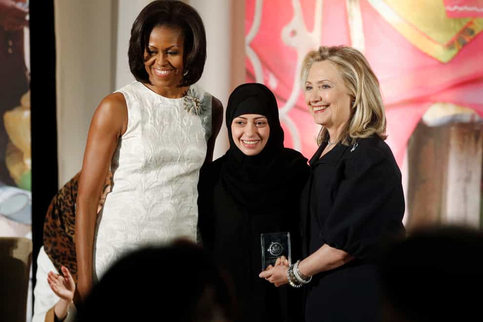 Michelle Obama, left, and Hillary Clinton, right, present the 2012 International Women of Courage Award to Samar Badawi at the State Department in Washington