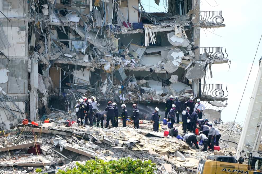 Rescue workers in the rubble of the collapsed Champlain Towers South apartment building