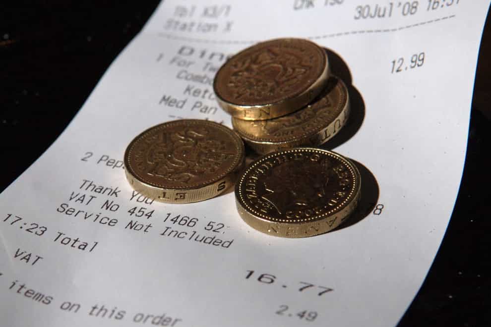 Pound coins on top of a restaurant bill