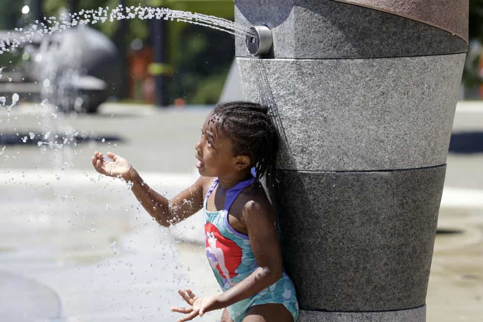 Mellena O’Brien, four, plays in the Yesler TerraceSpray Park during a heat wave hitting the Pacific Northwest