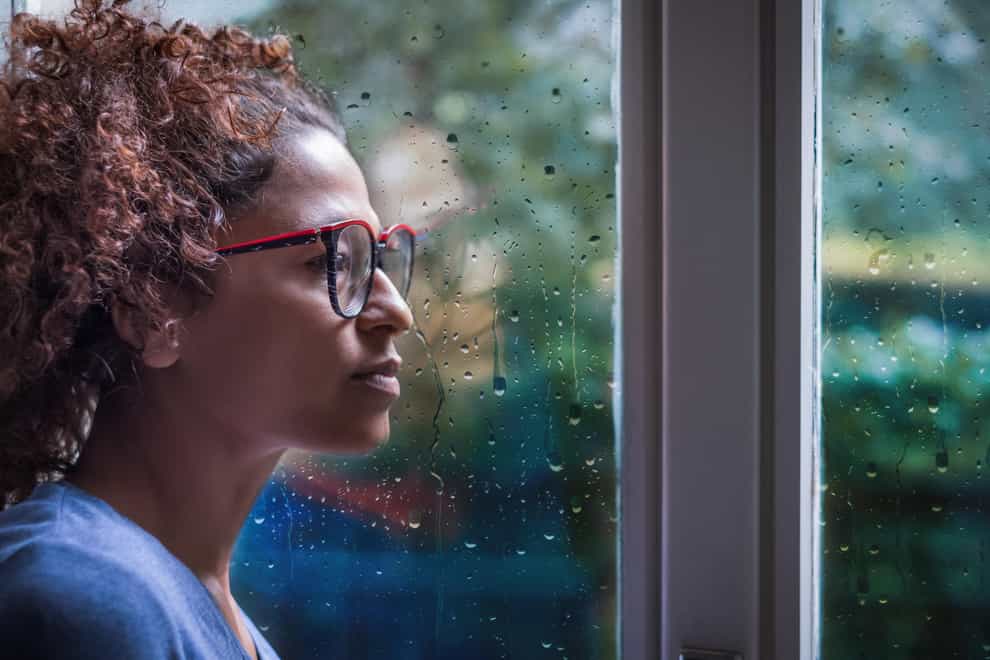 woman looking sadly out of window