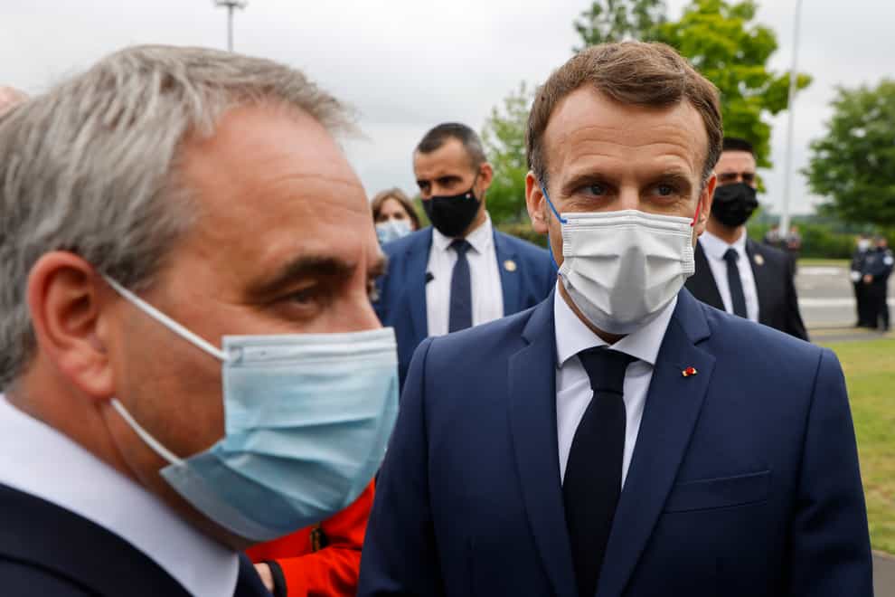 French President Emmanuel Macron, is welcomed by conservative northern France region president Xavier Bertrand, left, upon his arrival to visit the site of the future factory of Japan-based battery maker Envision AESC group (Ludovic Marin/AP)