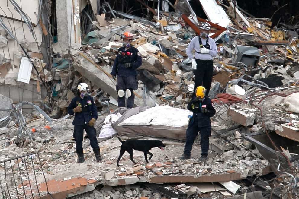 South Florida Urban Search and Rescue team look through rubble for survivors at the partially collapsed Champlain Towers South condo building