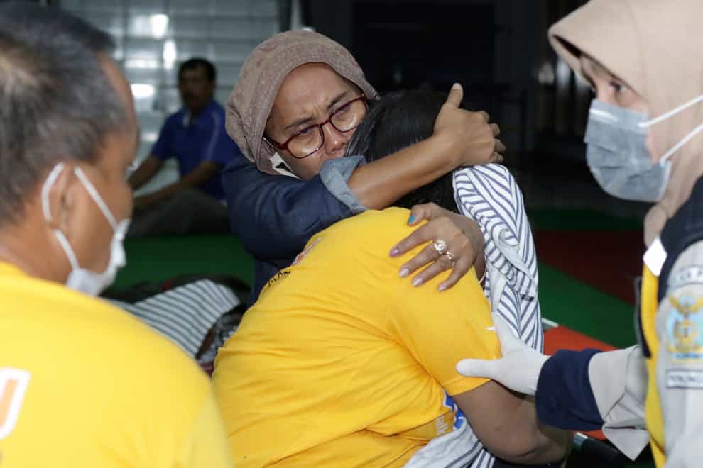 A relative embraces a survivor of the sinking ferry KMP Yunice at an evacuation point in Banyuwangi, East Java, Indonesia