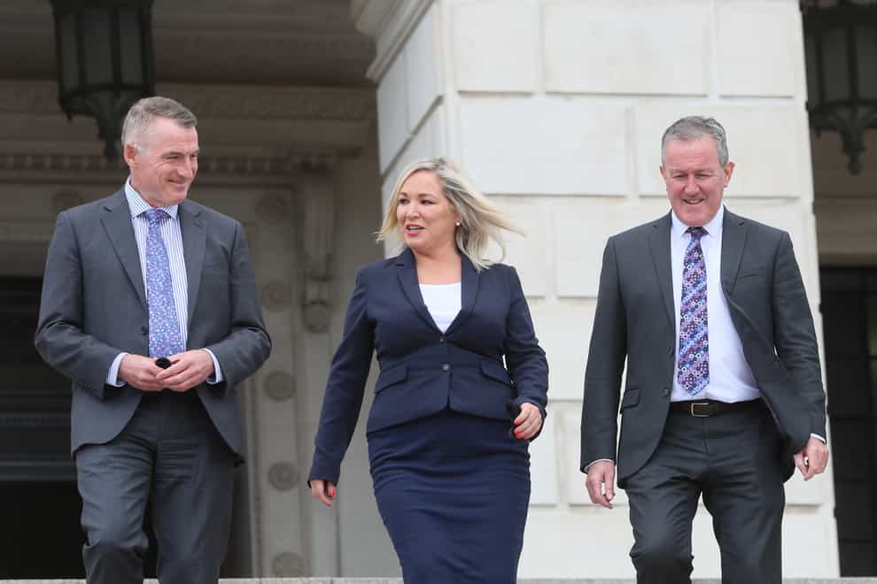 Declan Kearney, Michelle O'Neill and Conor Murphy walk down the stairs of Stormont