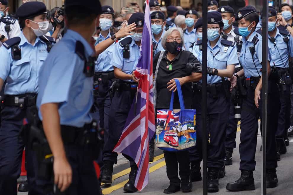 A protester holding a UK flag is arrested by police in Hong Kong