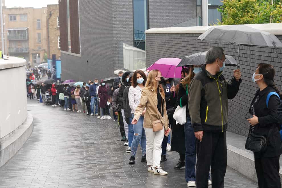 People queue outside an NHS vaccination clinic at Tottenham Hotspur’s stadium in north London