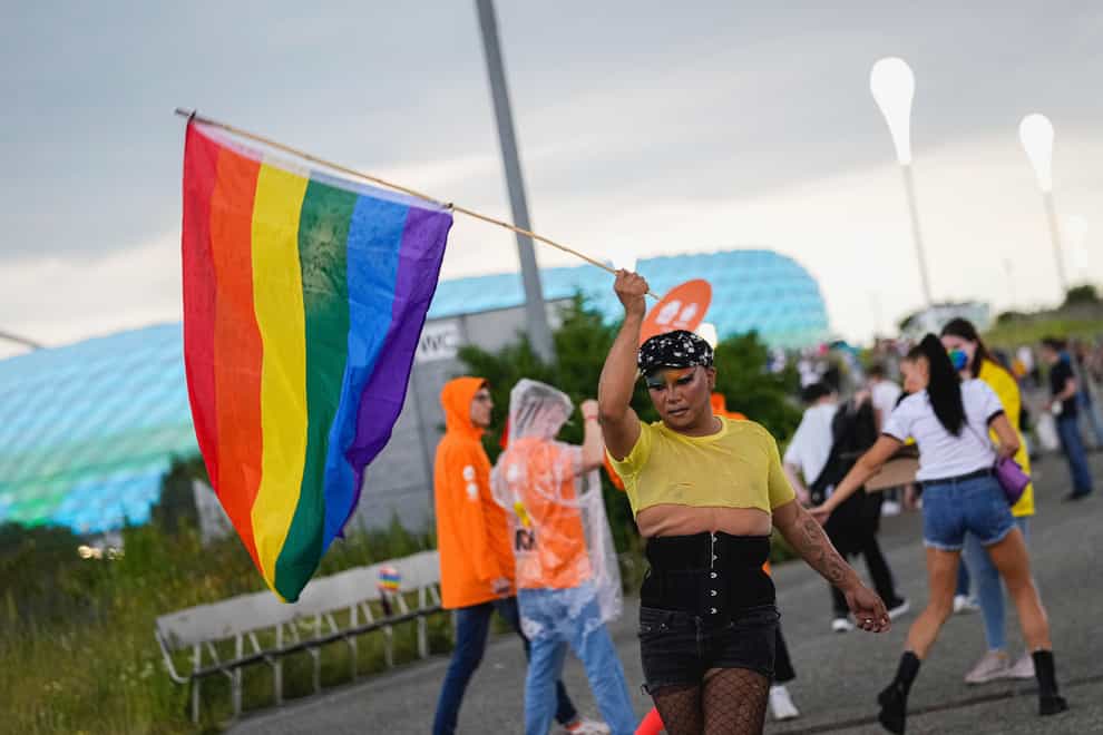 A fan waves a rainbow flag ahead of the Germany v Hungary match on June 23