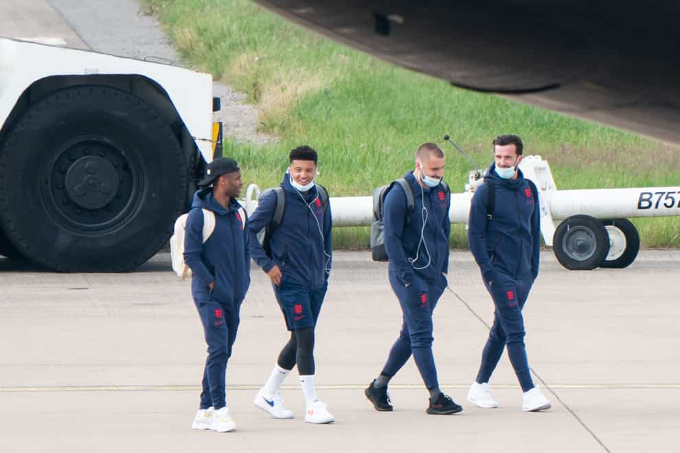 England’s Raheem Sterling, Jadon Sancho, Luke Shaw and Ben Chilwell on the tarmac heading to board the plane
