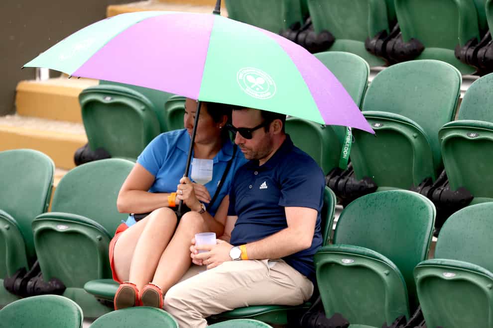 A couple with an umbrella at Wimbledon