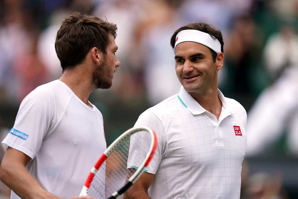 Cameron Norrie (left) chats to Roger Federer after their third-round match