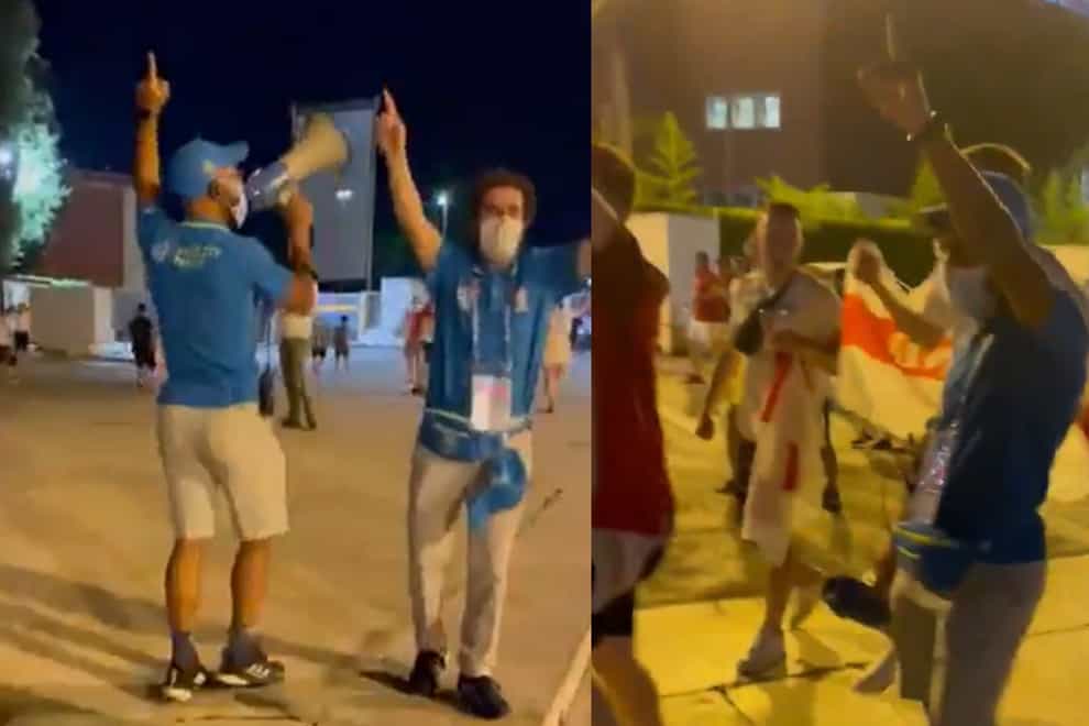 England fans sing It's Coming Home with a steward after the Euro 2020 quarter-final in Rome