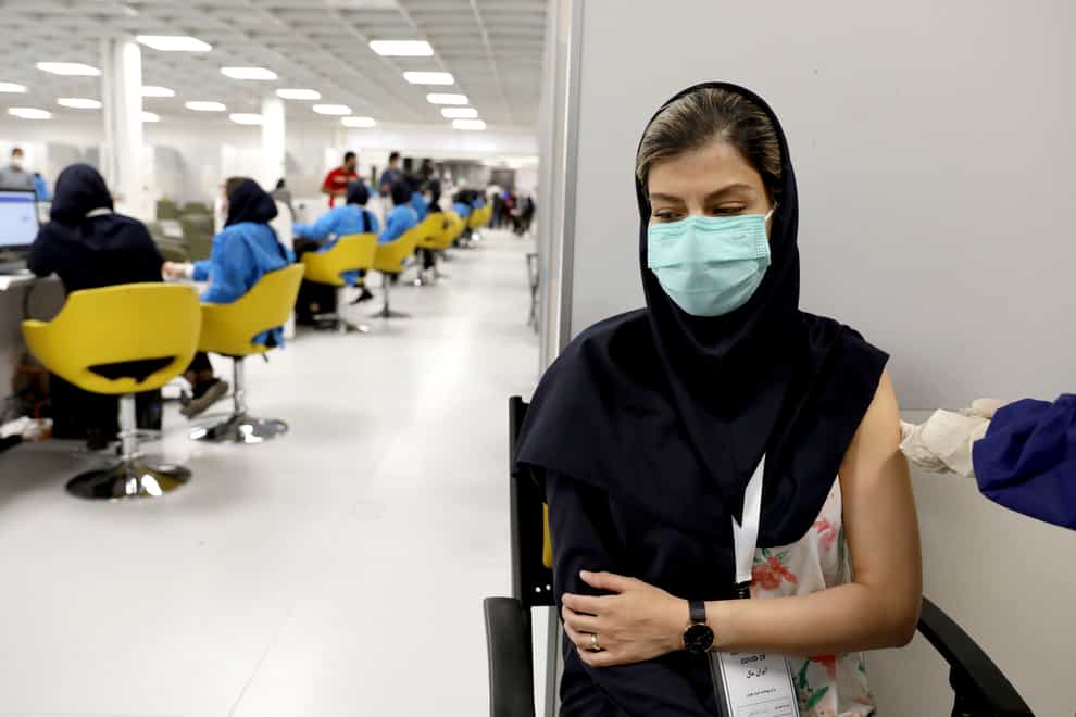 A medical worker receives a Covid-19 vaccination in Tehran