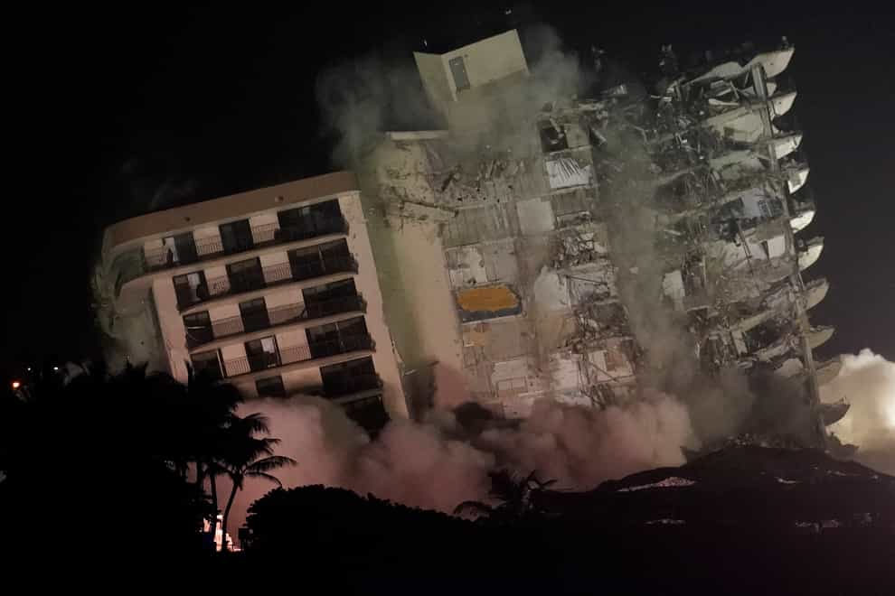 The damaged remaining structure at the Champlain Towers South condo building collapses in a controlled demolition