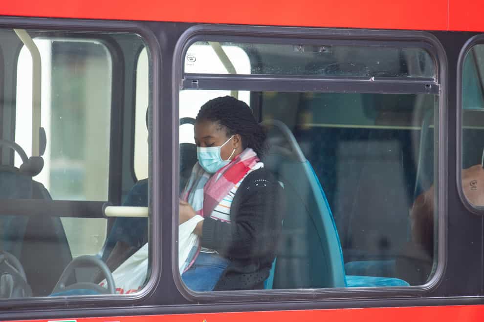 A bus passenger wearing a face covering