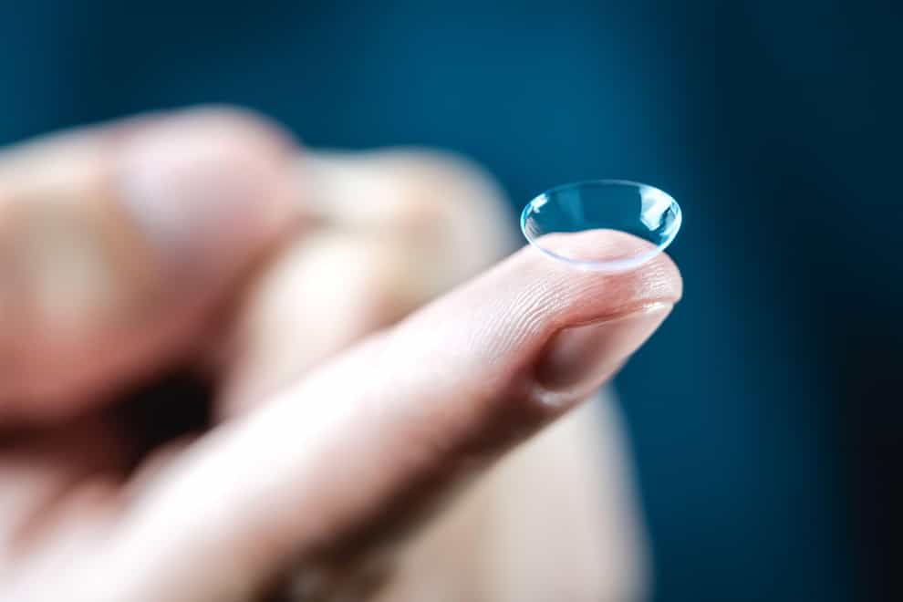<p>Contact lens on finger</p>