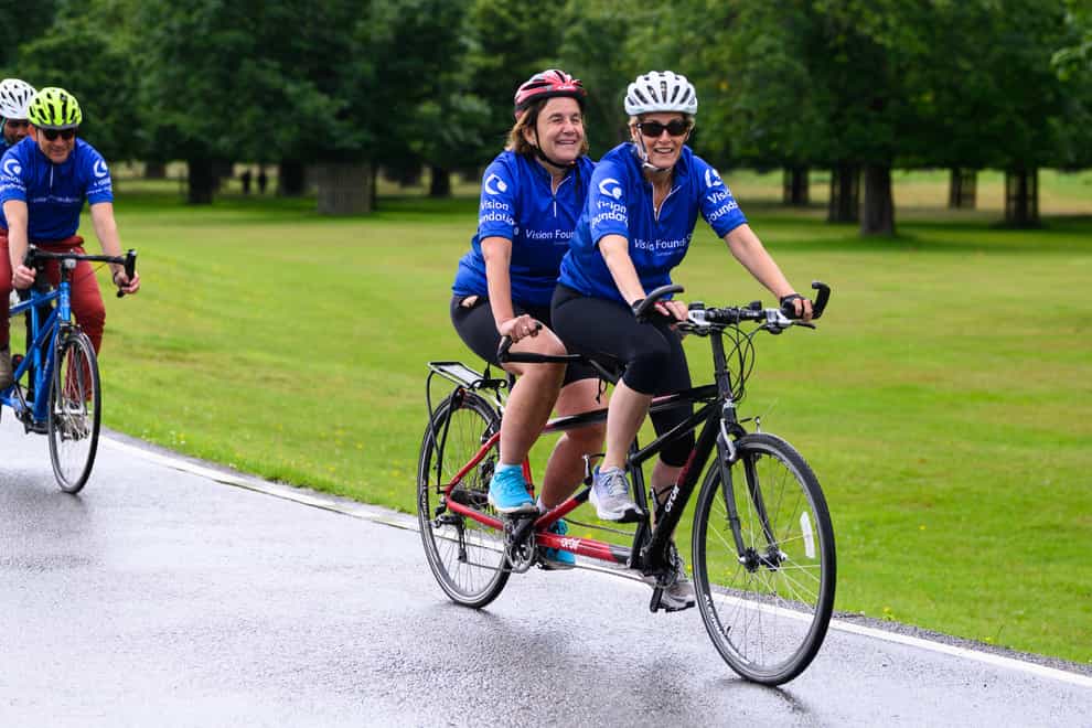The Countess of Wessex joins Monica Smith on a tandem bike ride with the Vision Foundation in Bushy Park, London