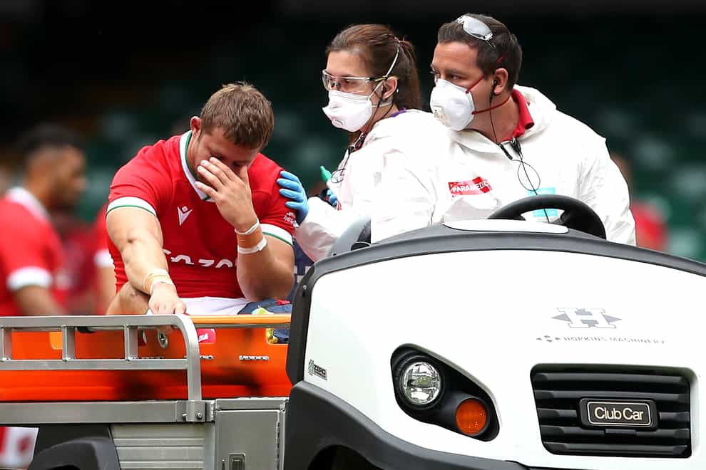 Leigh Halfpenny, left, leaves the pitch on a medical cart against Canada
