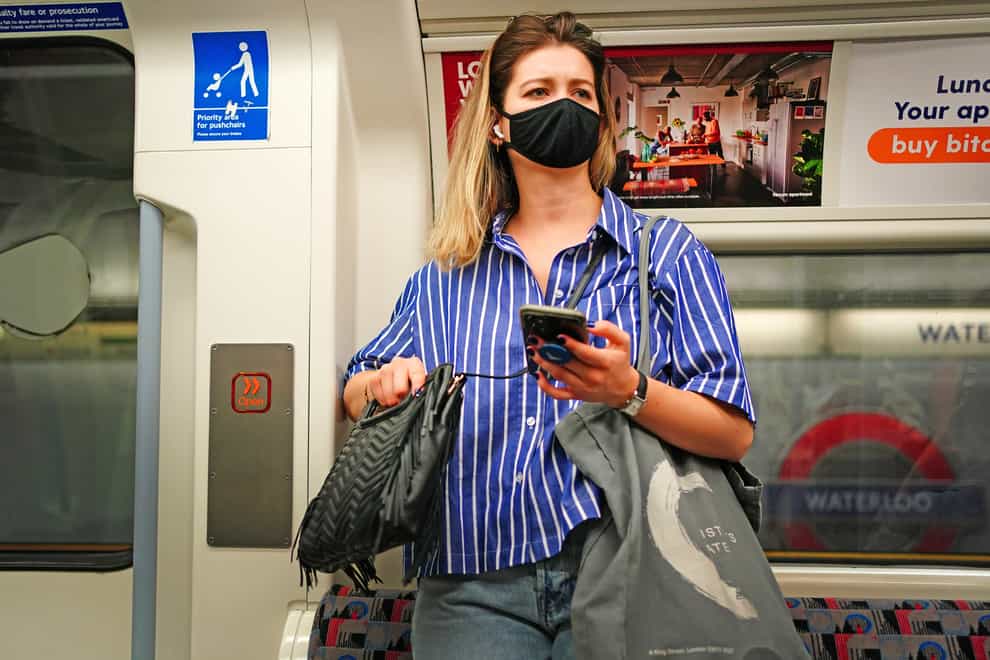 Tube passenger in face mask