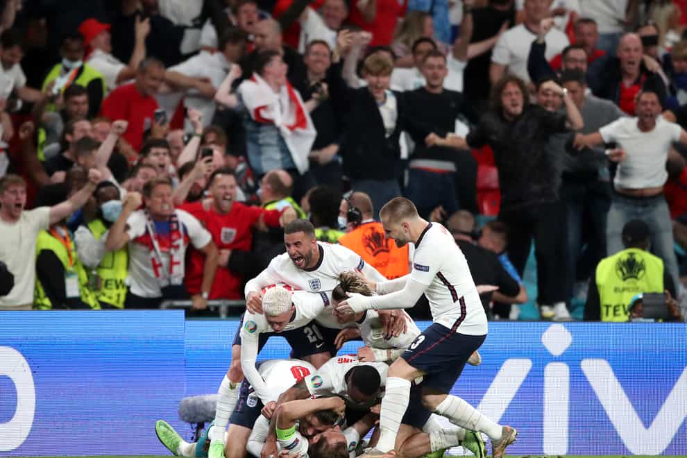 England’s Harry Kane is mobbed by team-mates after scoring their side’s second goal of the game in extra-time