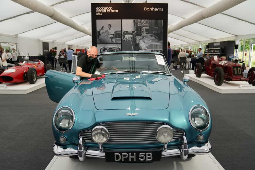Chris Bailey, of Bonhams, cleans the 1964 Aston Martin DB5 convertible