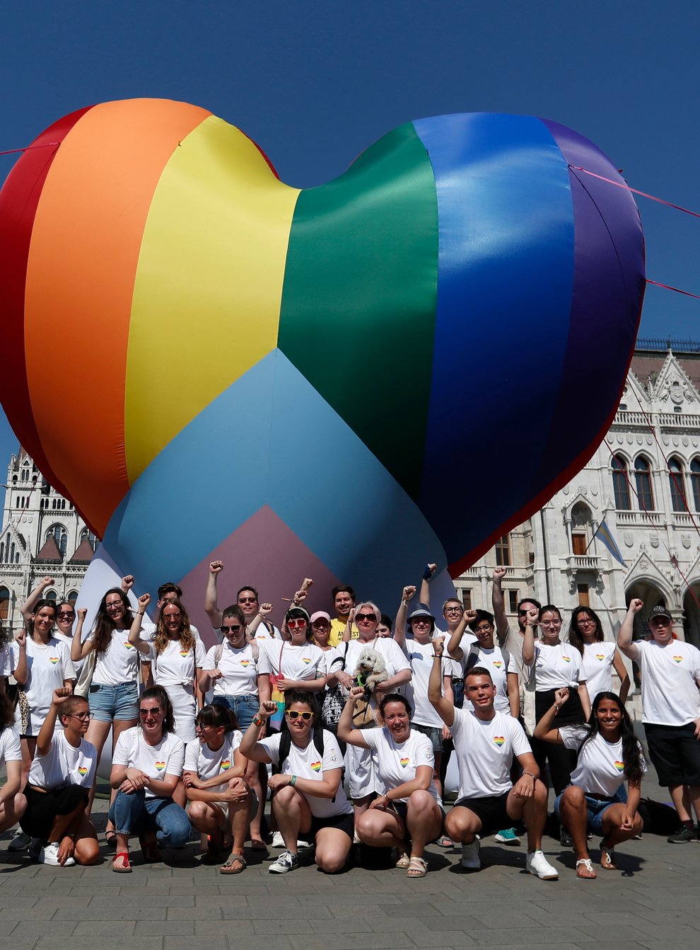 Activists pose for a photo after erecting a large rainbow-coloured heart in front of the country’s parliament building in Budapest, Hungary (Laszlo Balogh/AP)