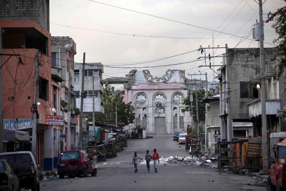 Children walk on an empty street in front of the cathedral that was destroyed by the 2010 earthquake in Port-au-Prince, Haiti (Joseph Odelyn/AP)