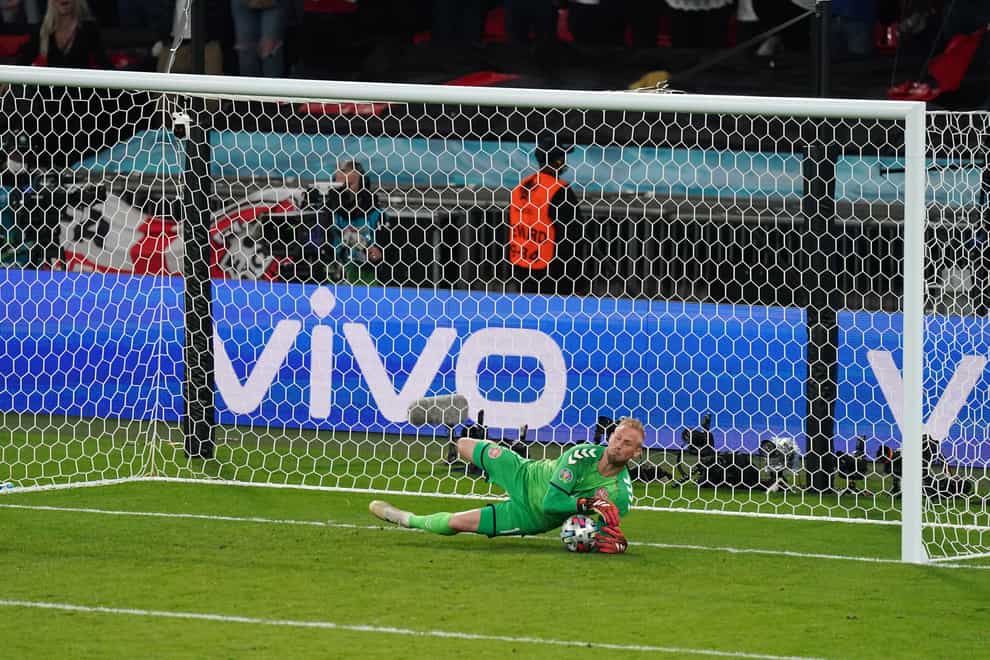 Denmark goalkeeper Kasper Schmeichel saves a penalty from England’s Harry Kane
