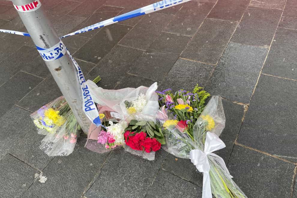 Flowers left near the scene in Woolwich New Road where Tamim Ian Habimana was fatally stabbed